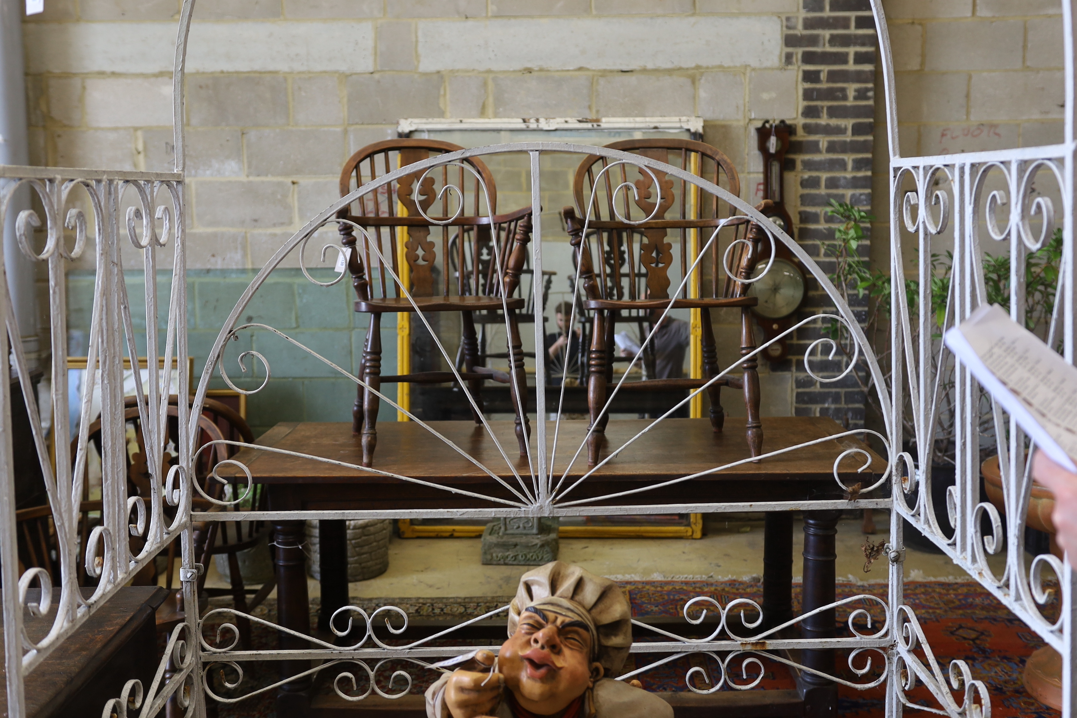 A painted wrought iron rose arbour garden seat, width 120cm, depth 62cm, height 218cm